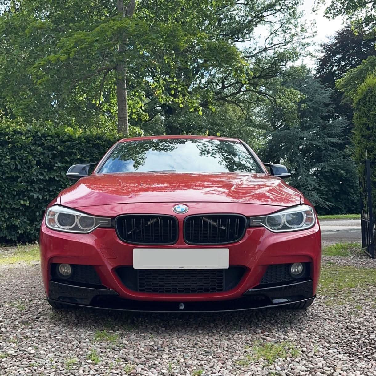 Gloss black front splitter for BMW F30 F31 3 Series M Sport, enhancing aerodynamics and sporty look.