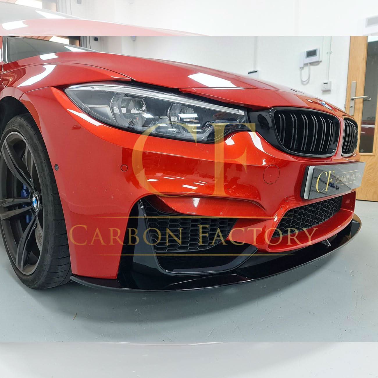 Gloss black MP style front splitter for BMW F80 M3, F82 F83 M4 models, showcasing its aerodynamic design and fitment.