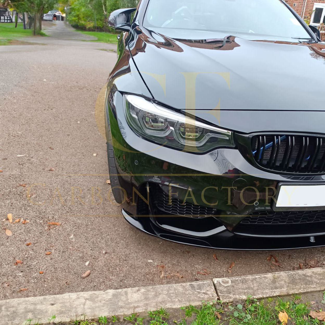 Gloss black MP style front splitter installed on a BMW F80 M3 and F82 F83 M4, enhancing sporty front aerodynamic look.