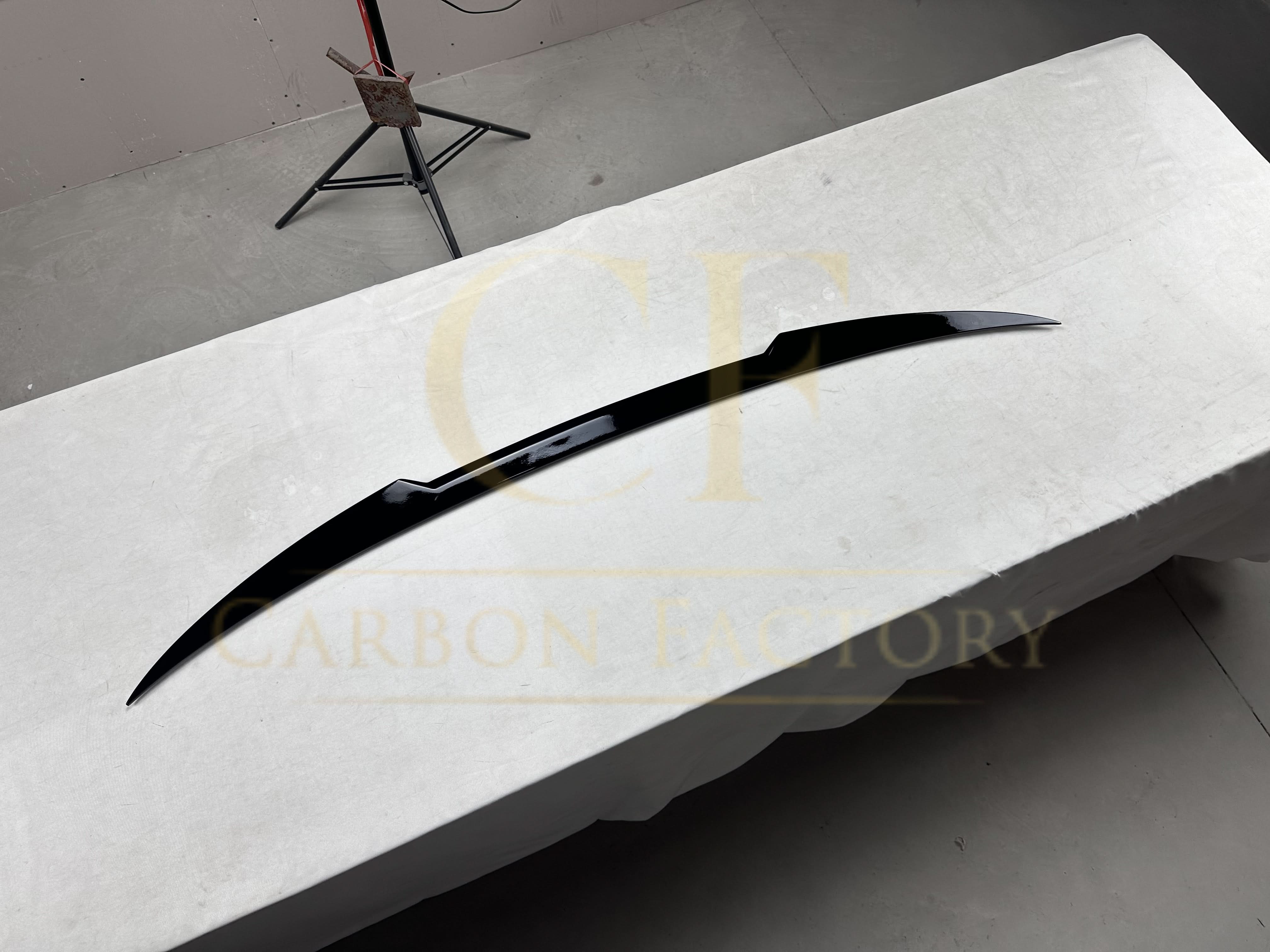 Gloss black mid spoiler for BMW F40 1 Series 19-24, showing the sleek, aerodynamic design and glossy finish on the car's rear.