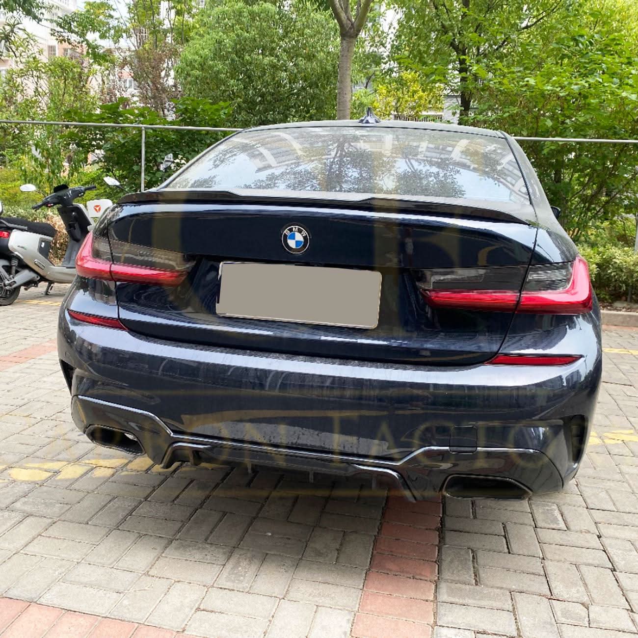Gloss black M3-style boot spoiler for BMW G20 3 Series and G80 M3, mounted on the trunk lid, enhances sporty rear appearance.