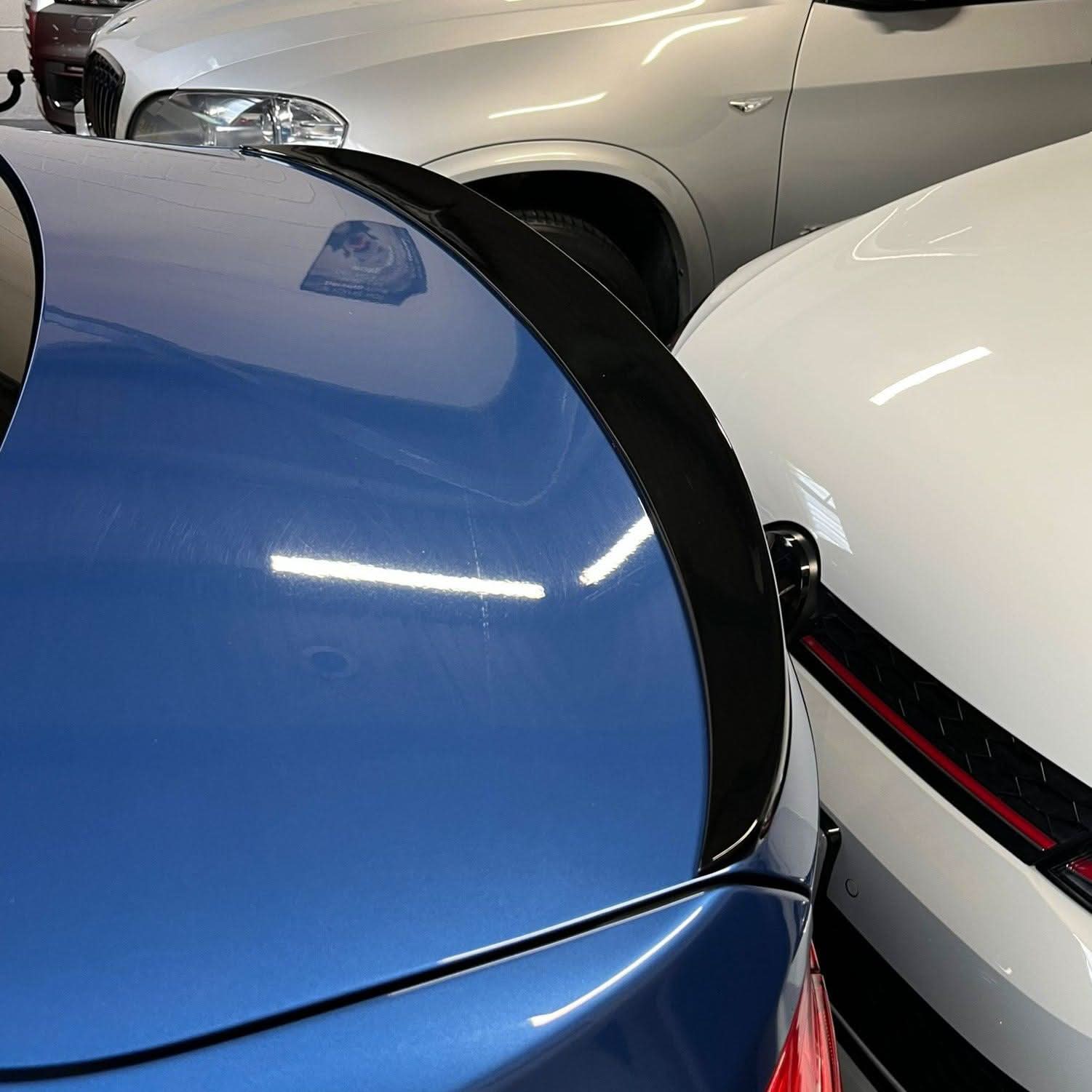 Gloss black boot spoiler for BMW 3 Series F30 F80 M3, styled for sporty look, shown on the rear of the saloon.