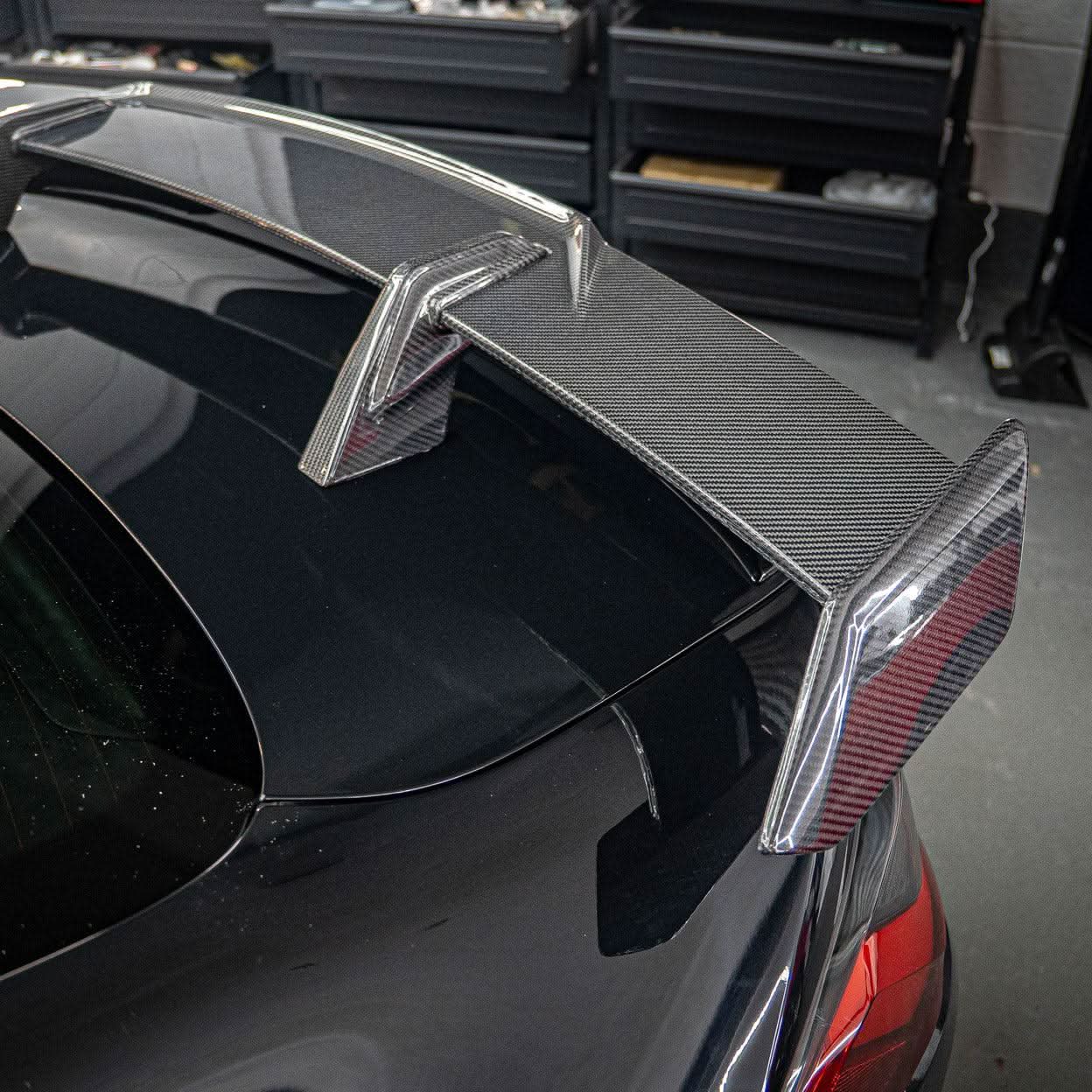Pre-Preg Carbon fibre boot spoiler for BMW G80 M3 and G82 M4, showcasing sleek aerodynamic design and high-quality material.