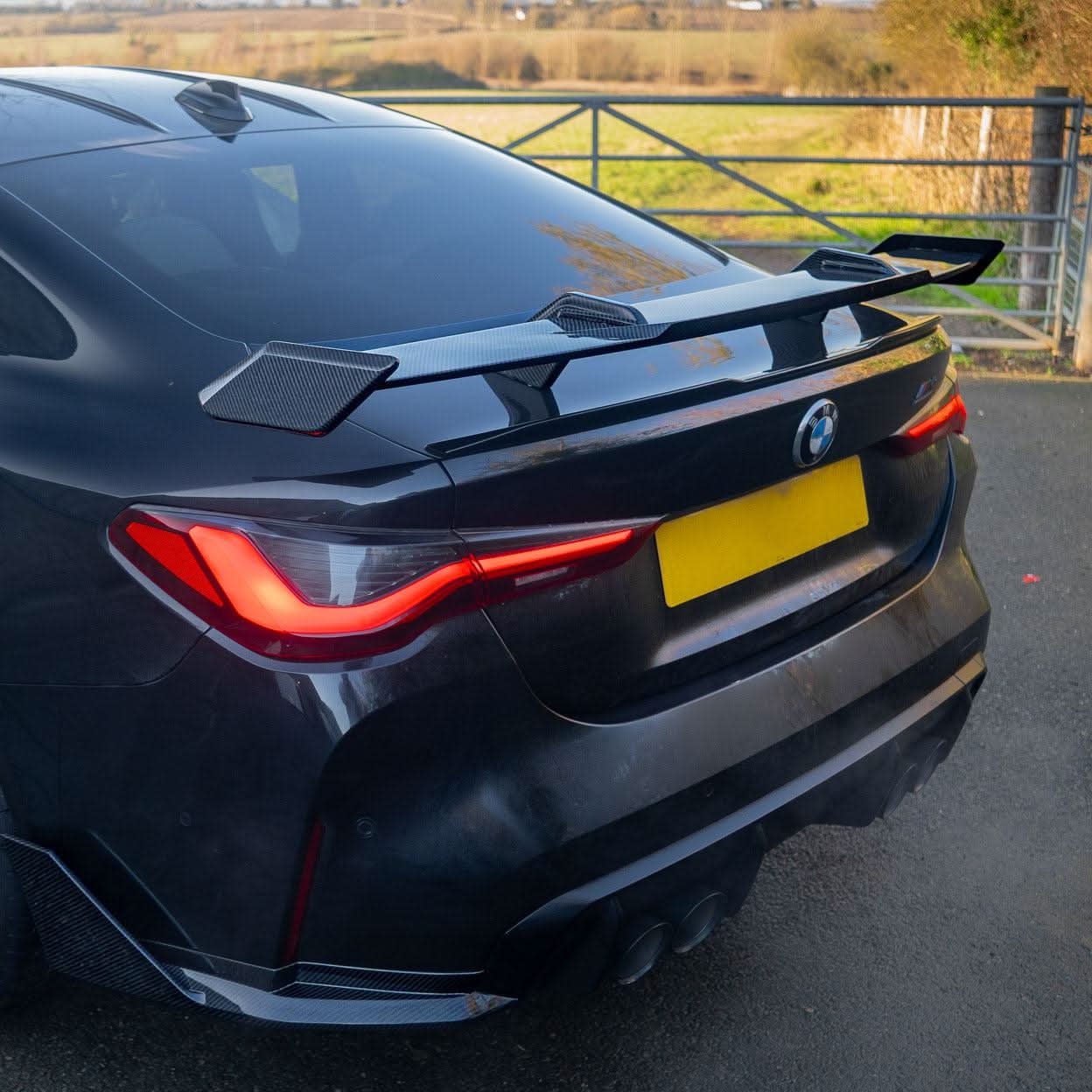 Pre-Preg Carbon fibre boot spoiler for BMW G80 M3 and G82 M4, showcasing sleek aerodynamic design on the vehicle.