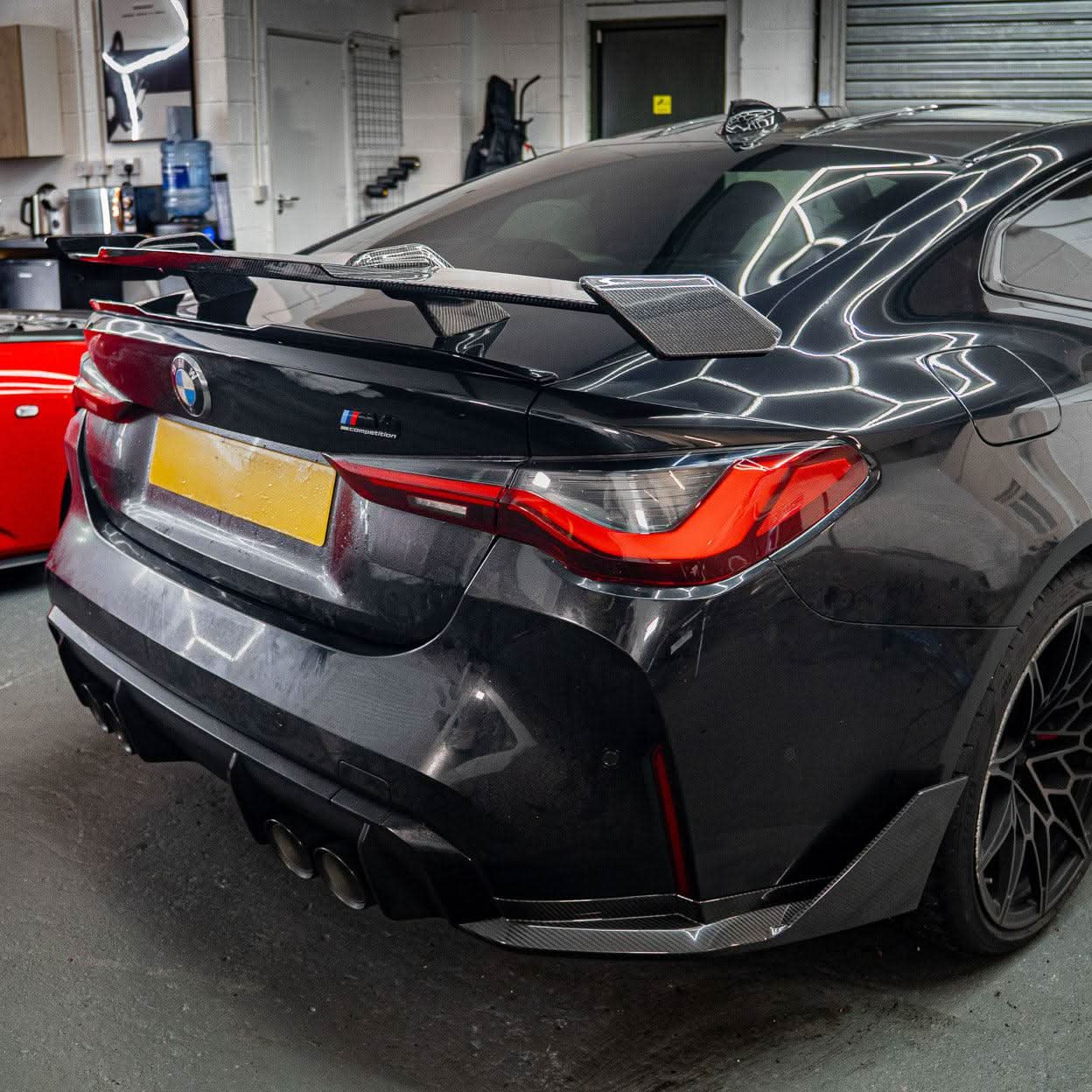 Pre-Preg carbon fiber boot spoiler for BMW G80 M3 and G82 M4 models, featuring a sleek, aerodynamic design.