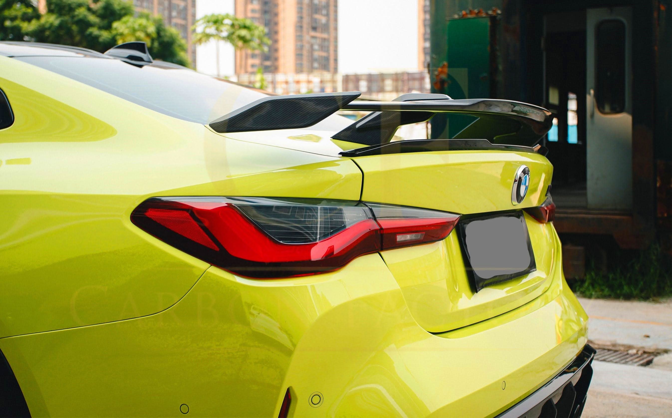 Pre-Preg carbon fibre boot spoiler for BMW G80 M3 and G82 M4, enhanced aerodynamic design, mounted on car trunk.