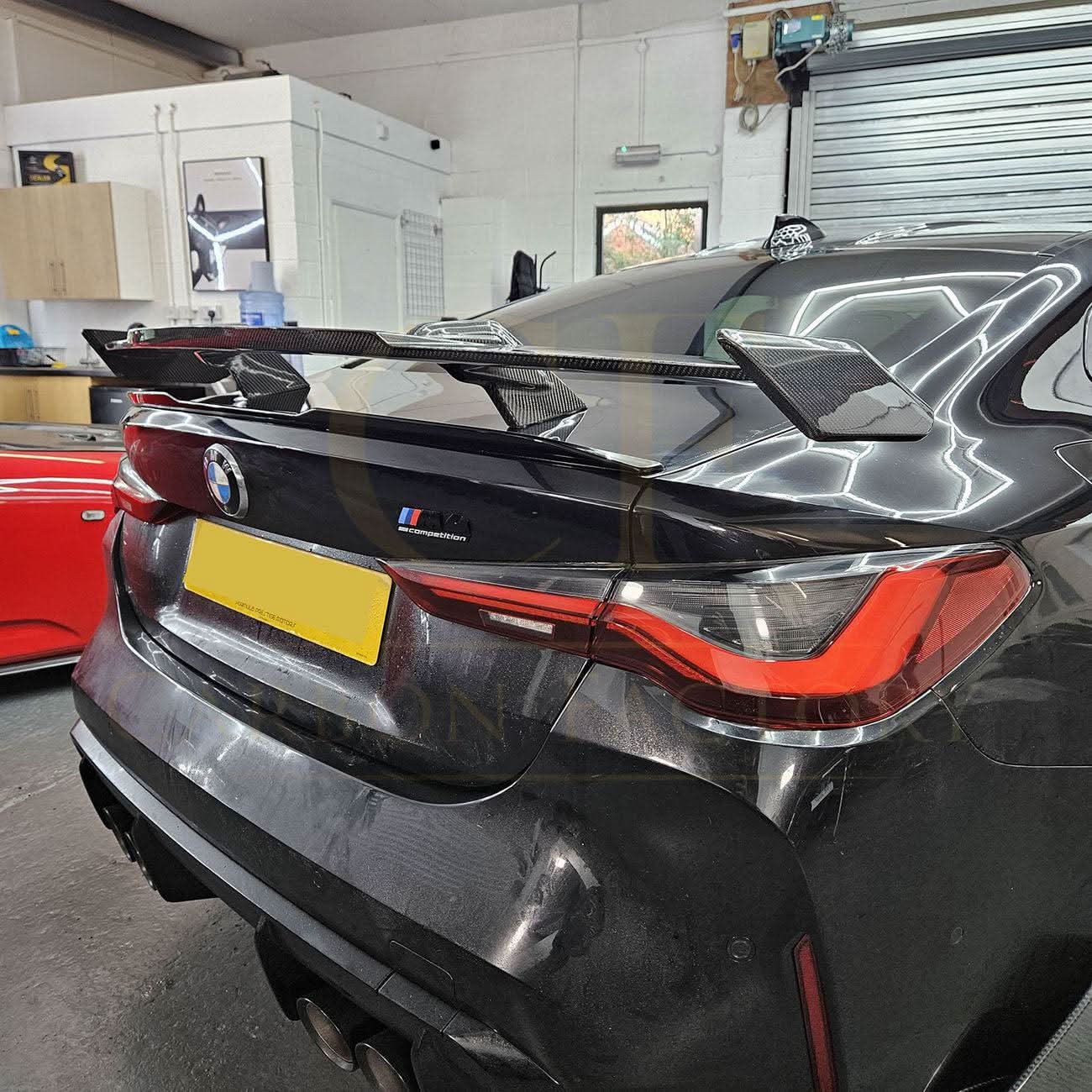 Pre-Preg Carbon fibre boot spoiler for BMW G80 M3 and G82 M4, showcasing sleek aerodynamic design on a black car.