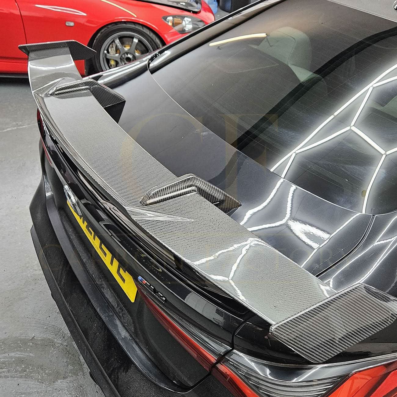 Pre-Preg Carbon fibre boot spoiler for BMW G80 M3 and G82 M4, featuring sleek design and aerodynamic enhancement.