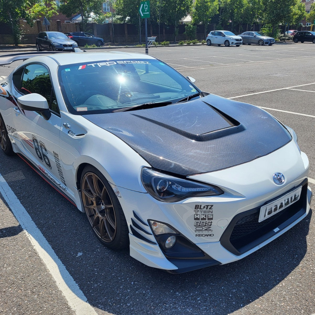 Carbon fibre bonnet for Toyota GT86 2012-2020, exterior trim part with sleek textured finish, designed for enhanced style and aerodynamics.